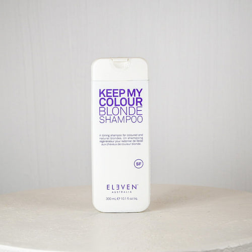 Shampoo bottle labeled 'Keep My Colour Blonde Shampoo' by Eleven Australia on a white surface with a gray background.