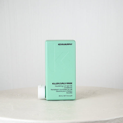 Kevin Murphy Killer Curls Rinse bottle on a white surface with a light gray background