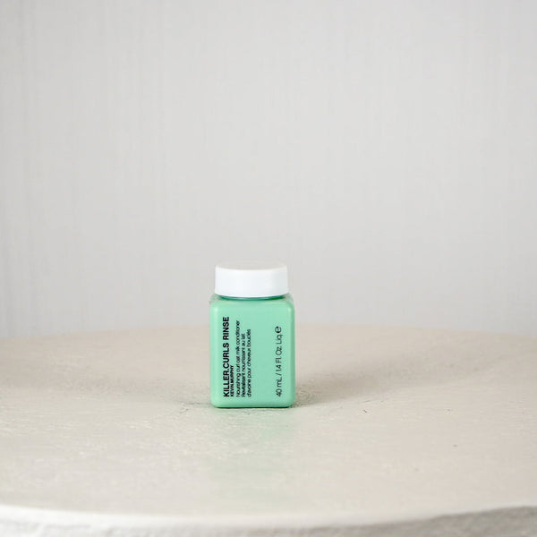 Green bottle with white cap on a light gray surface