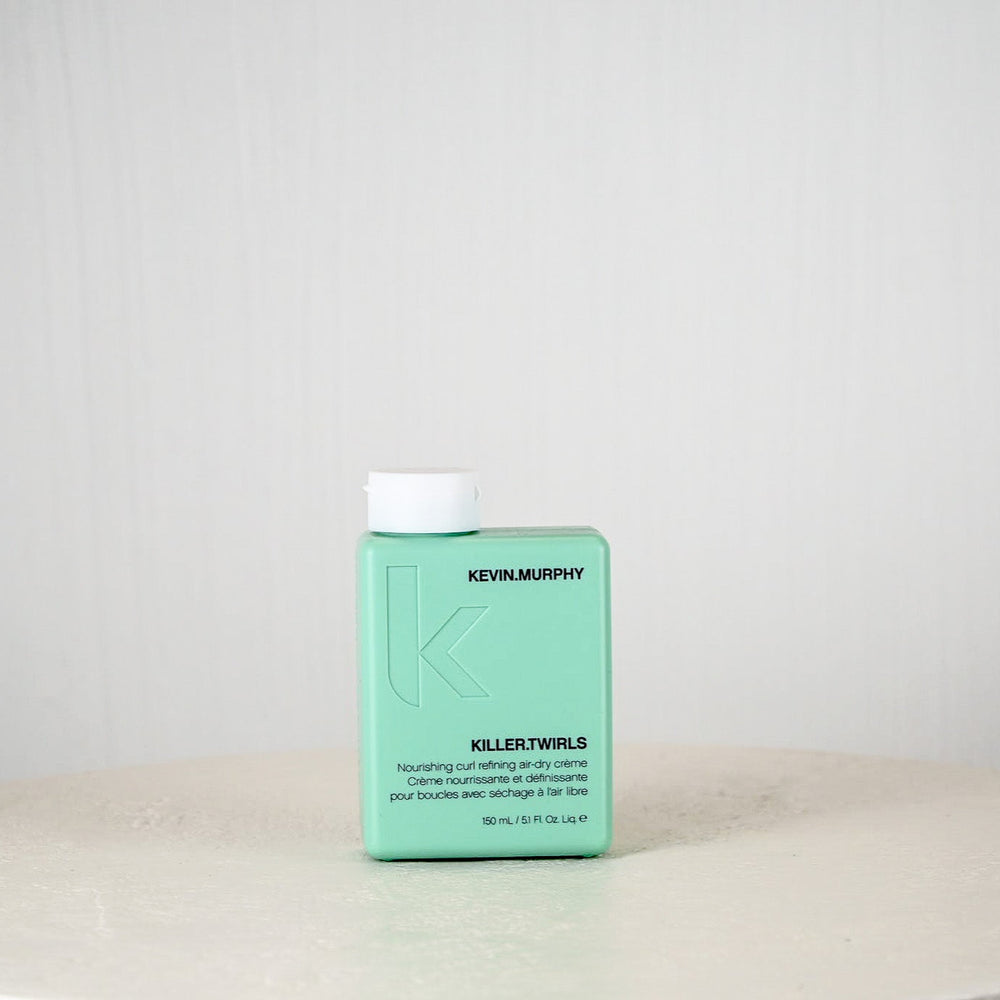 Kevin Murphy hair product bottle on a white surface with a light gray background