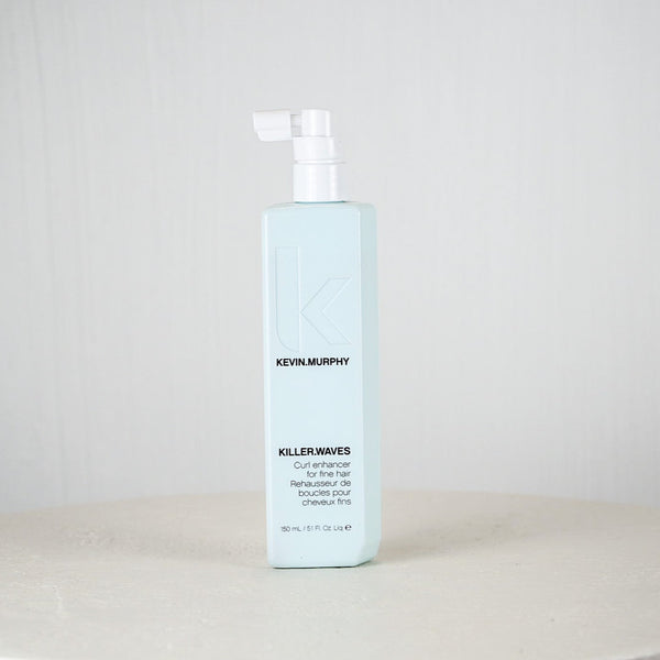 Kevin Murphy hair product bottle on a white surface with a light gray background