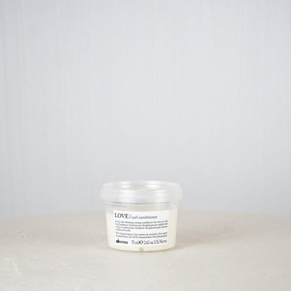 White jar with label on a white surface and light gray background
