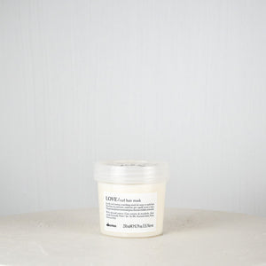 White hair mask jar with black text on a white background
