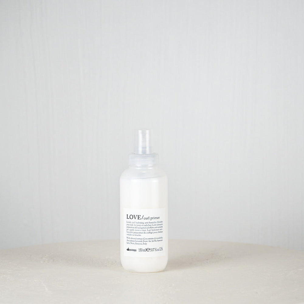 White bottle with a label on a white surface and light gray background