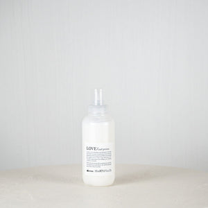 White bottle with a label on a white surface and light gray background