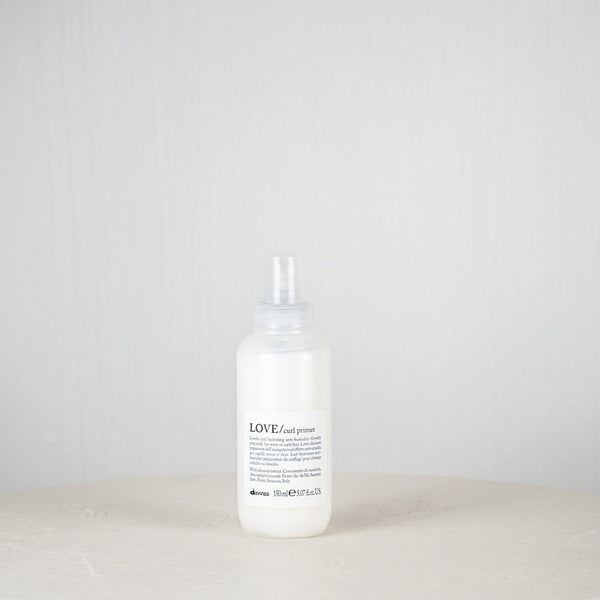 White bottle with a label on a white surface and light gray background