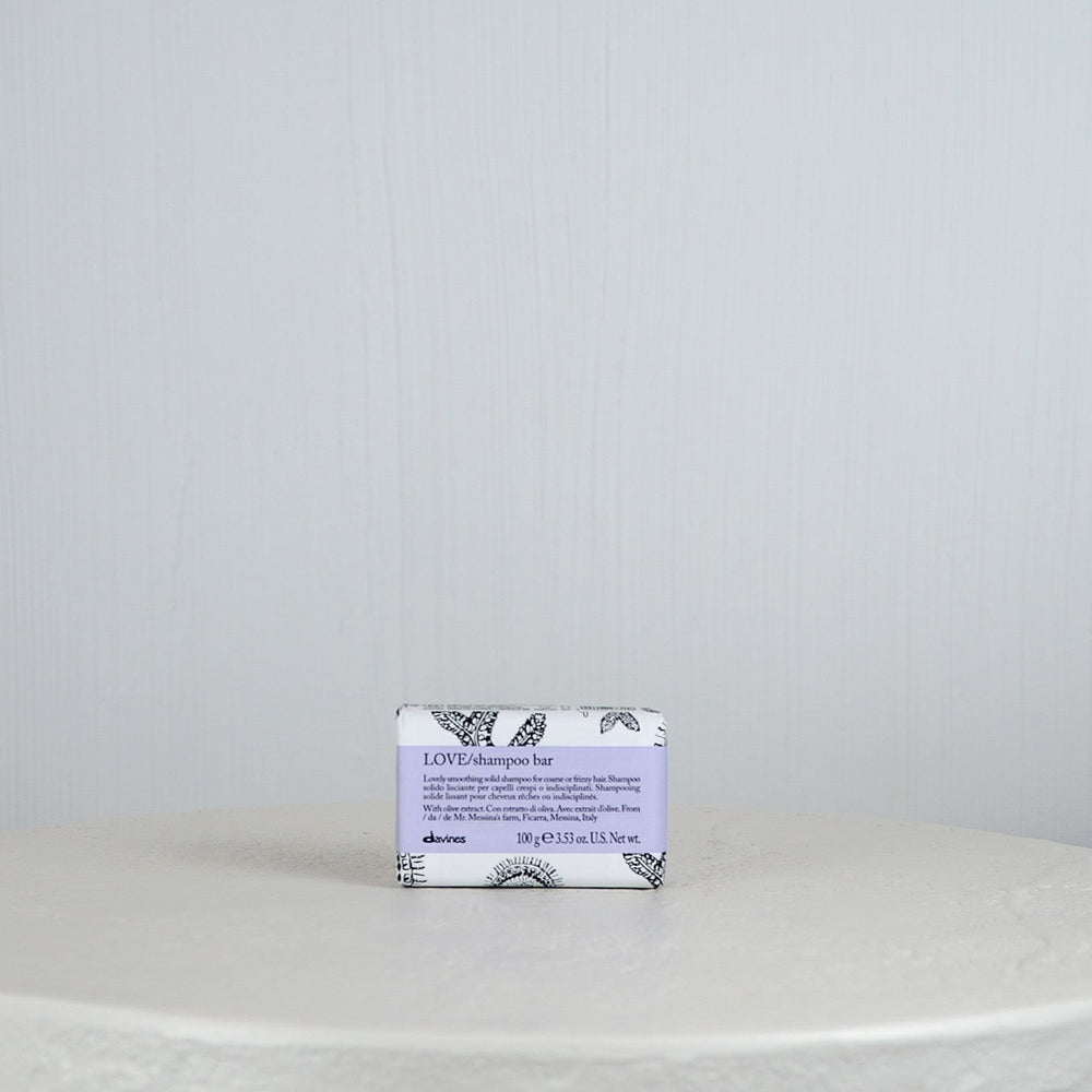 Bar of soap with a decorative label on a white surface and light gray background