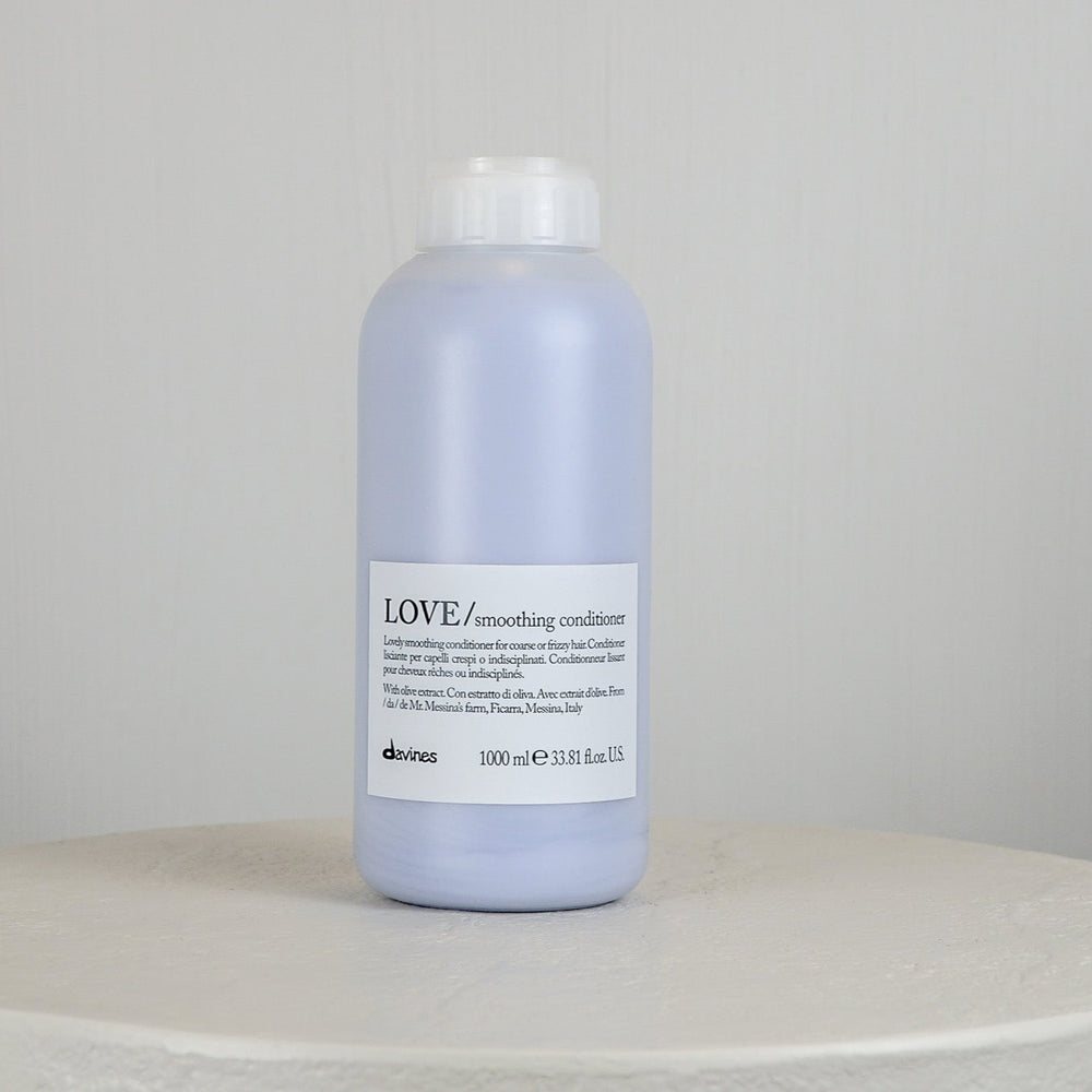 Jar of Davines LOVE conditioner on a white surface with a light gray background