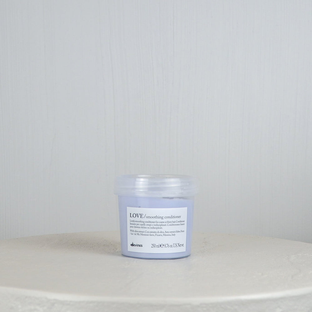 Jar of Davines LOVE conditioner on a white surface with a light gray background
