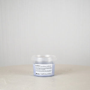 Small blue container with a white label on a light gray background