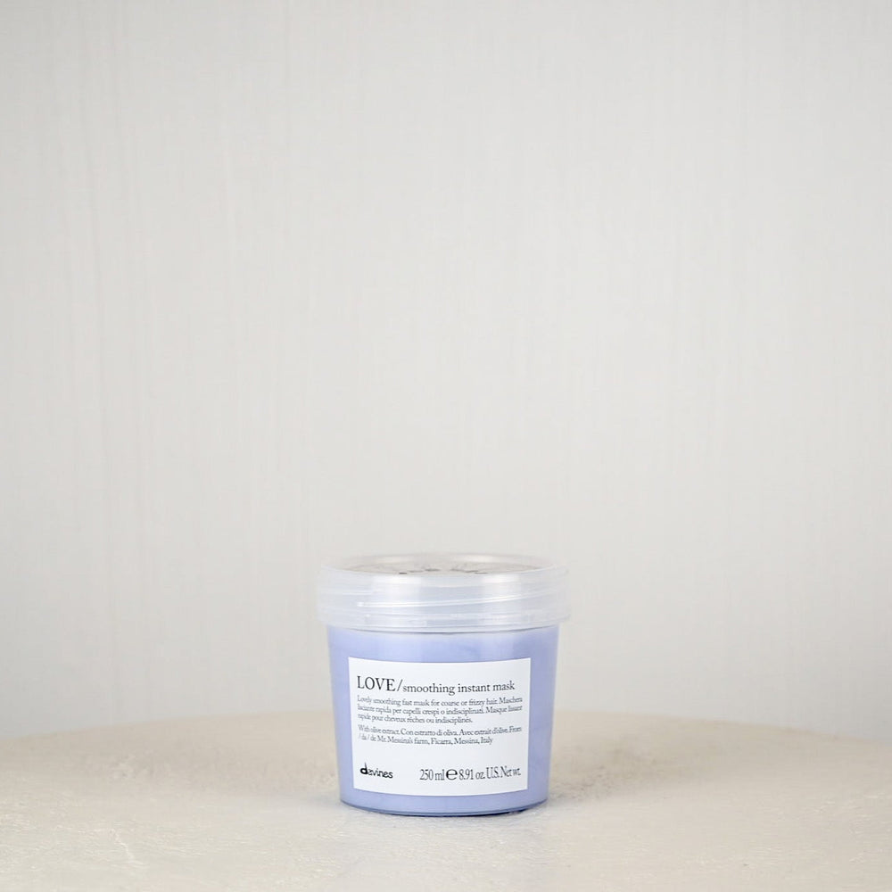 Jar of Davines hair product on a white surface with a light gray background