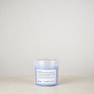 Jar of Davines hair product on a white surface with a light gray background