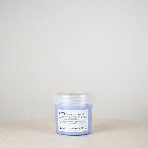 Jar of Davines hair product on a white surface with a light gray background
