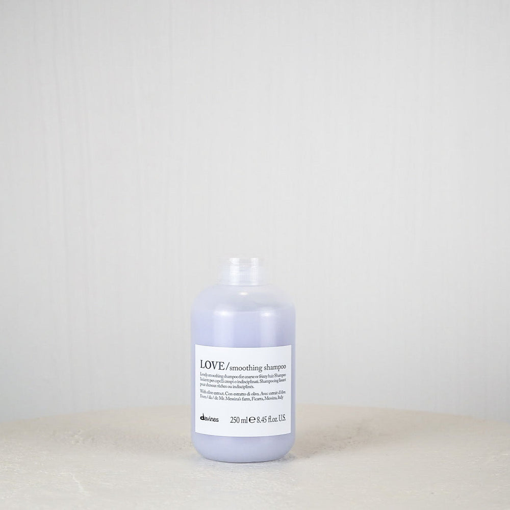 Bottle of Davines LOVE shampoo on a white surface with a light gray background