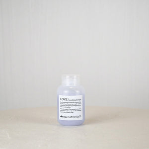 Bottle of Dove body wash on a white surface with a white background