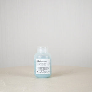 Bottle of Davines hair product on a white surface with a light gray background