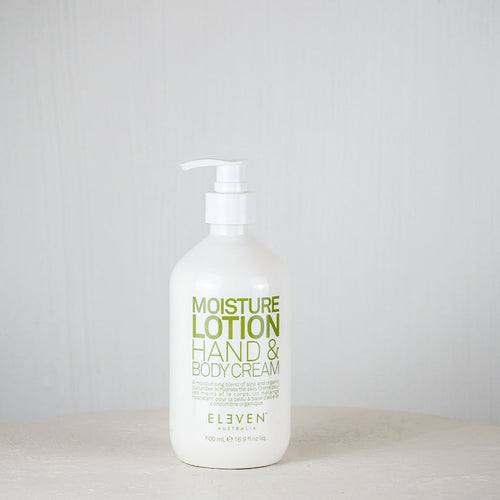 Bottle of moisture lotion on a white surface with a gray background