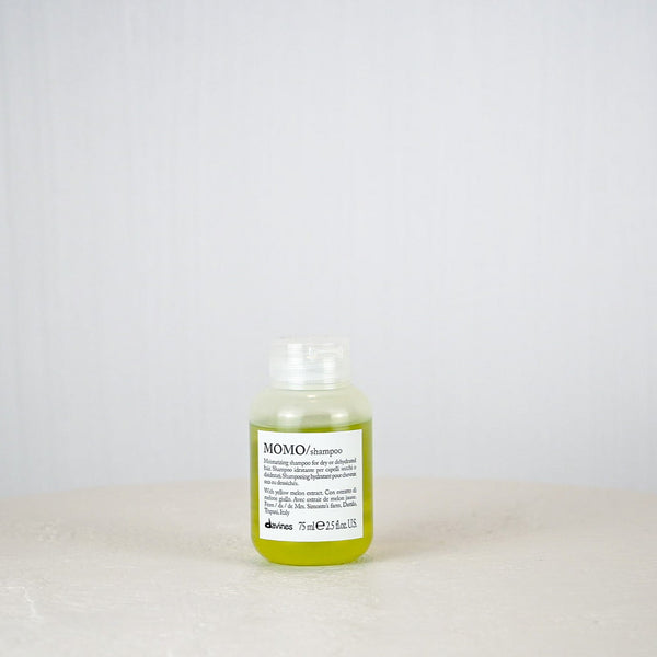 Bottle of Momo shampoo on a white background