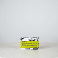 Bar of soap with a yellow label on a white background