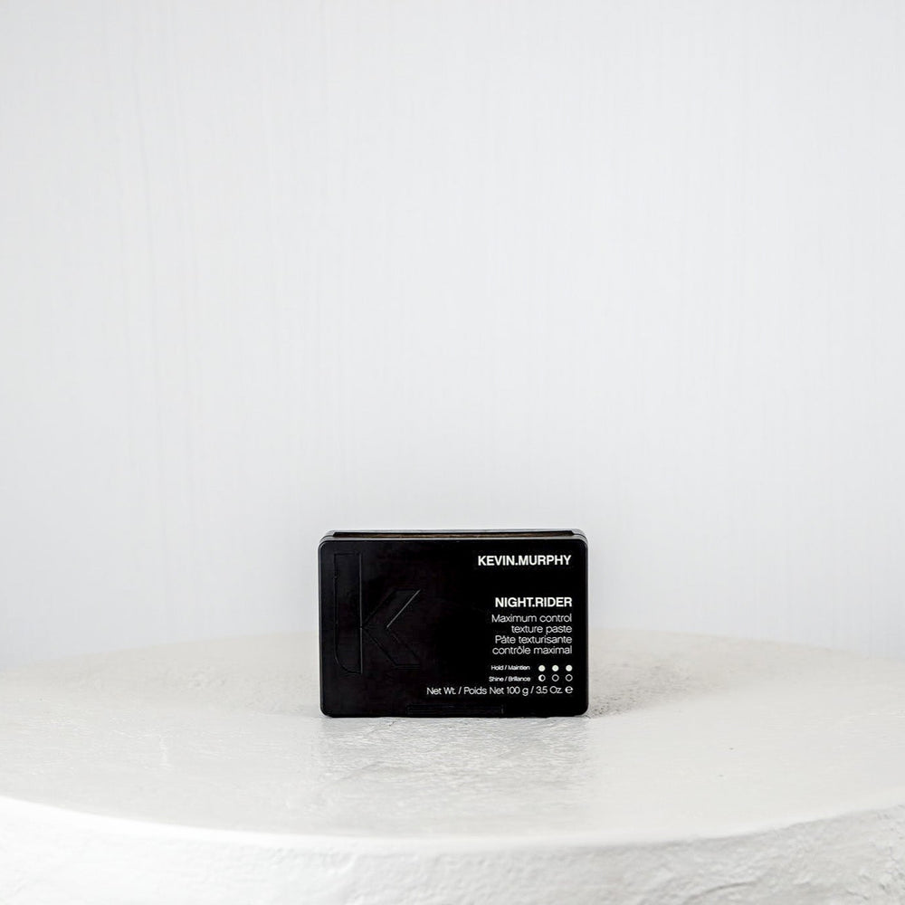 Black hair product packaging on a white background