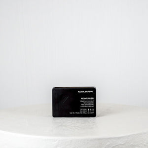 Black hair product packaging on a white background