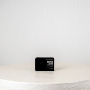 Black rectangular product on a white surface with a light gray background