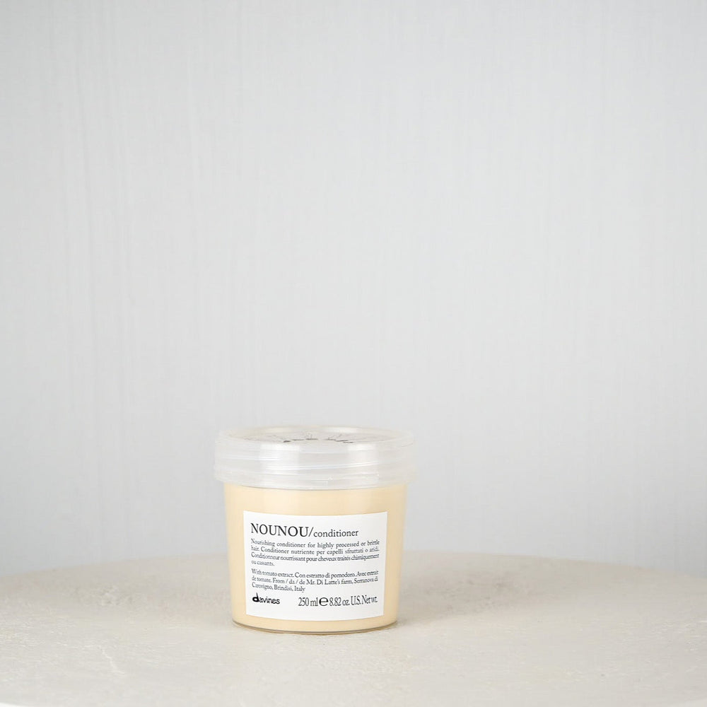 Jar of Davines hair product on a white surface with a light gray background