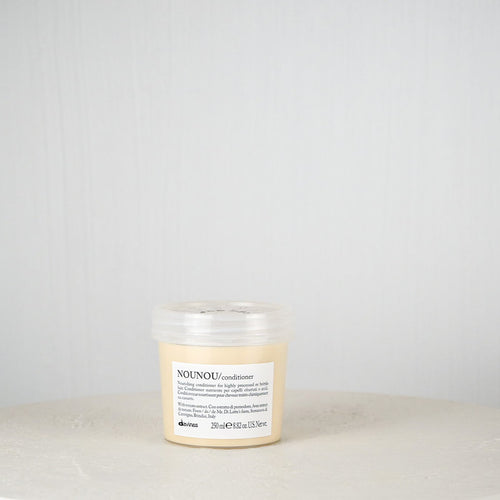 Jar of Davines hair product on a white surface with a light gray background