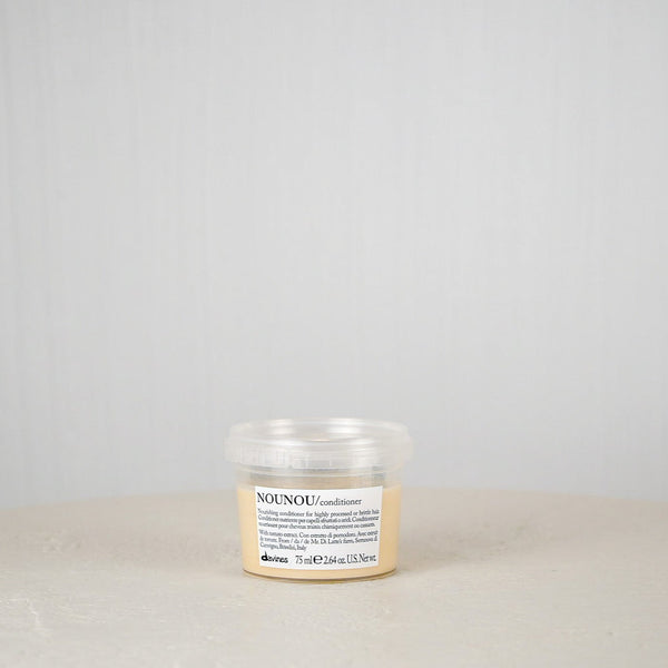 Jar of NOUNOU product on a white surface with a light gray background