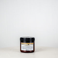 Jar of cream on a white surface with a white background