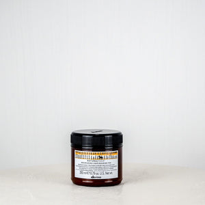 Jar of cream on a white surface with a white background