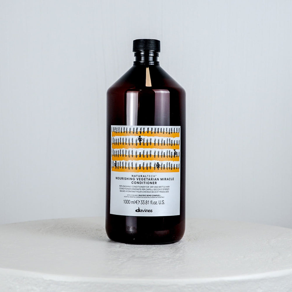Bottle of Davines hair product on a white background