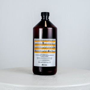 Bottle of Davines hair product on a white background