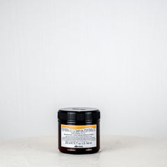 Jar of cream on a white surface with a white background