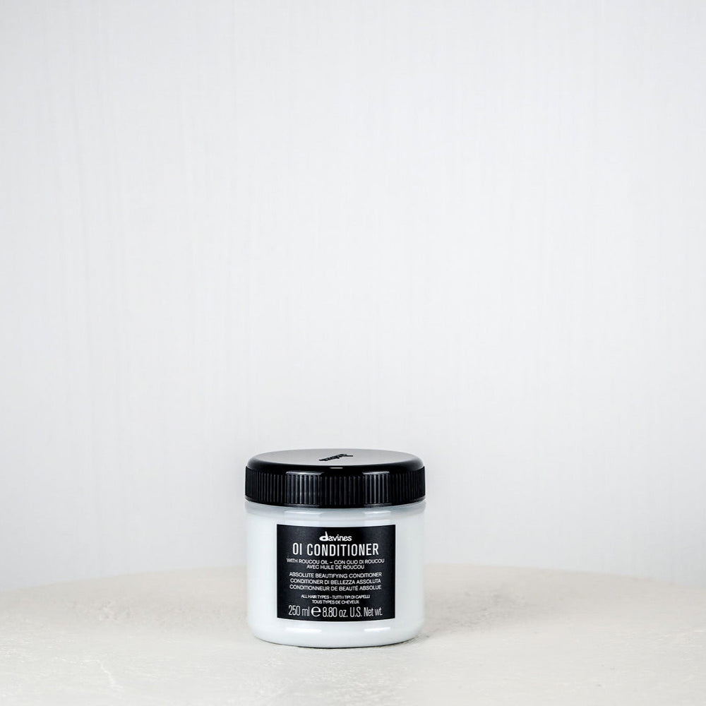 Jar of DANDY conditioner on a white background