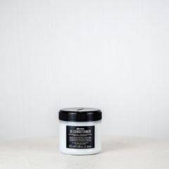 Jar of DANDY conditioner on a white background