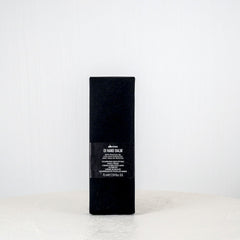 Black rectangular product box on a white surface with a light gray background