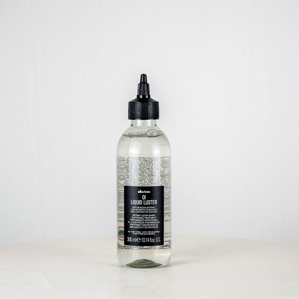 Bottle of Davines Oil Liquide Luster on a white background