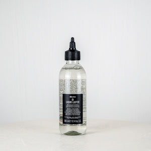 Bottle of Davines Oil Liquide Luster on a white background