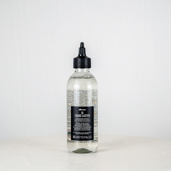 Bottle of Davines Oil Liquide Luster on a white background