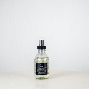 Bottle of Aesop product on a white surface with a white background