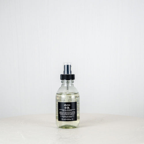 Bottle of Aesop product on a white surface with a white background