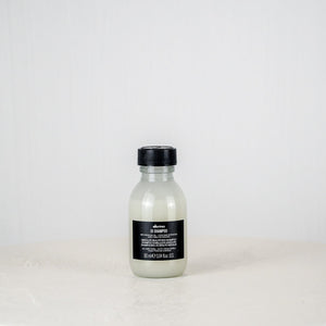 Bottle of Shu Uemura hair product on a white background
