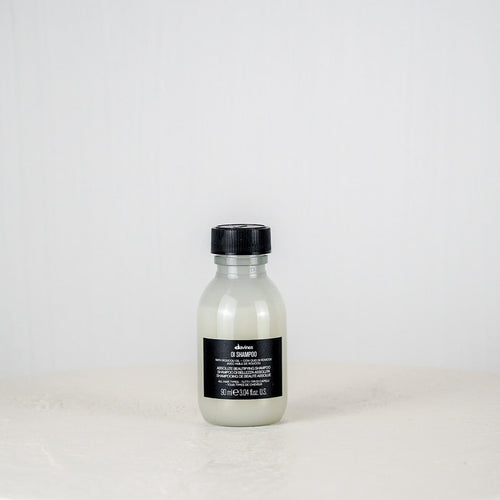 Bottle of Shu Uemura hair product on a white background