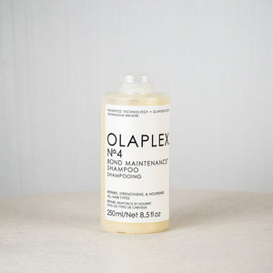 Olaplex No.4 Bond Maintenance Shampoo bottle on a light gray background