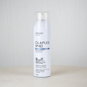 Olaplex No.4D hair treatment can on a white surface with a light gray background