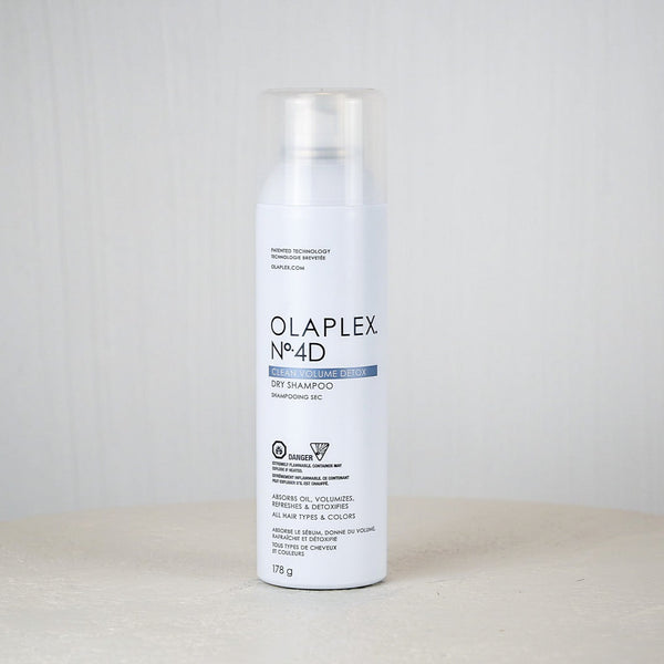Olaplex No.4D hair treatment can on a white surface with a light gray background