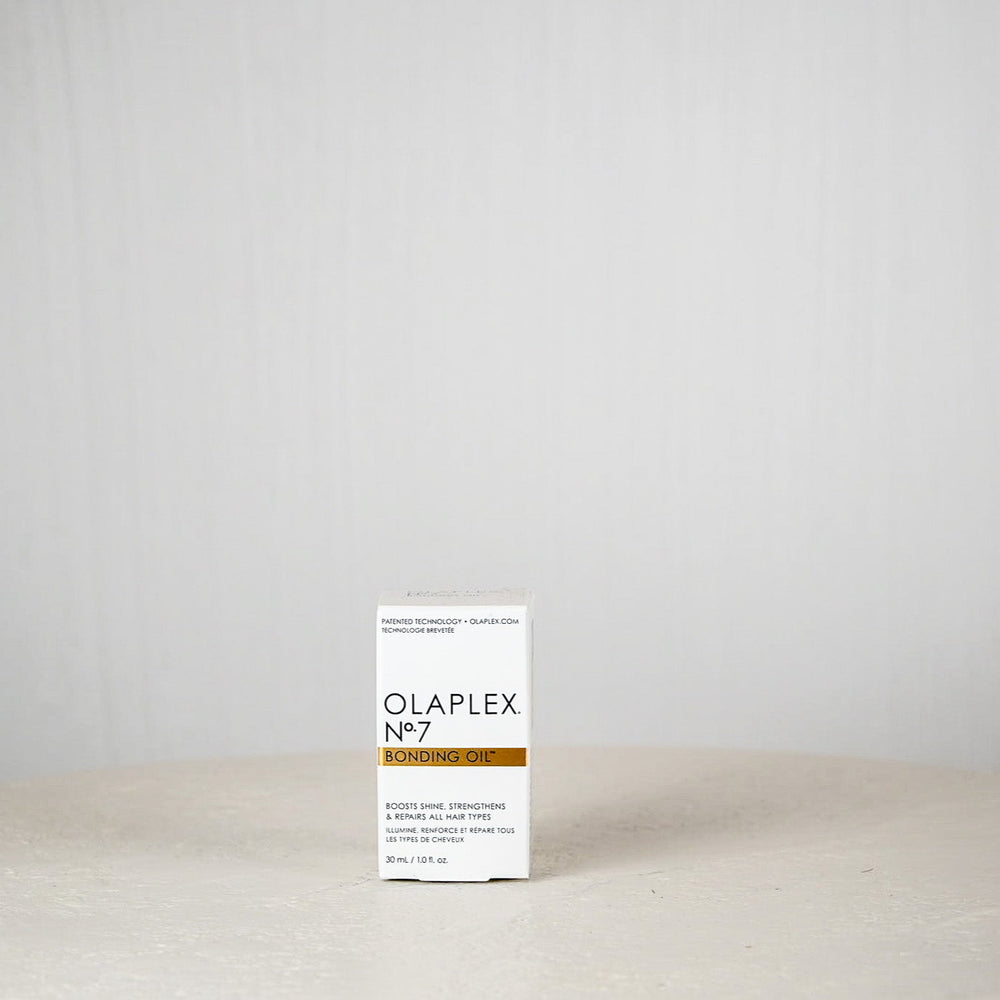 Olaplex No.7 product box on a white surface with a light gray background