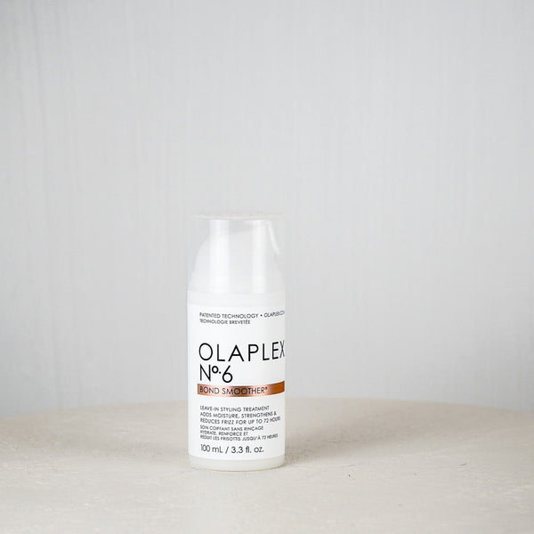 Olaplex bottle on a white surface with a light gray background