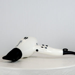 White hair dryer with black accents on a white background
